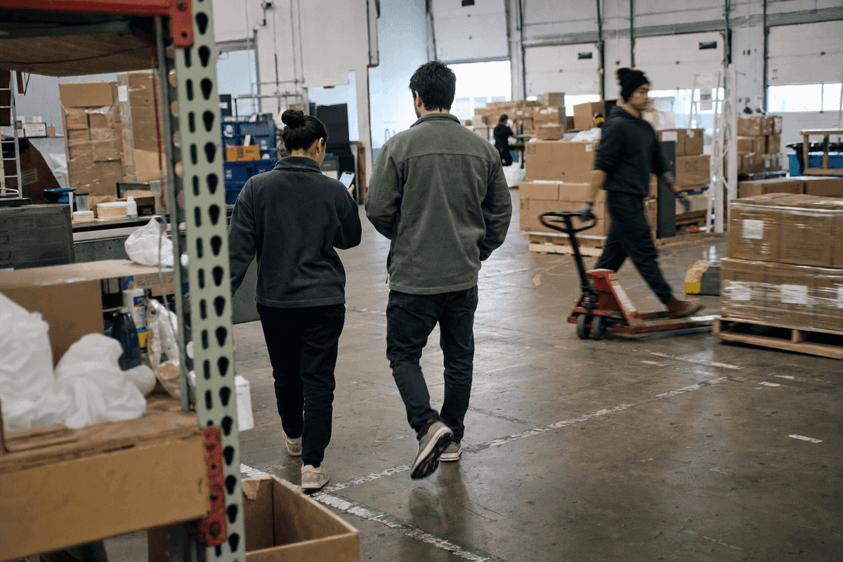 Two colleagues walking through a distribution facility