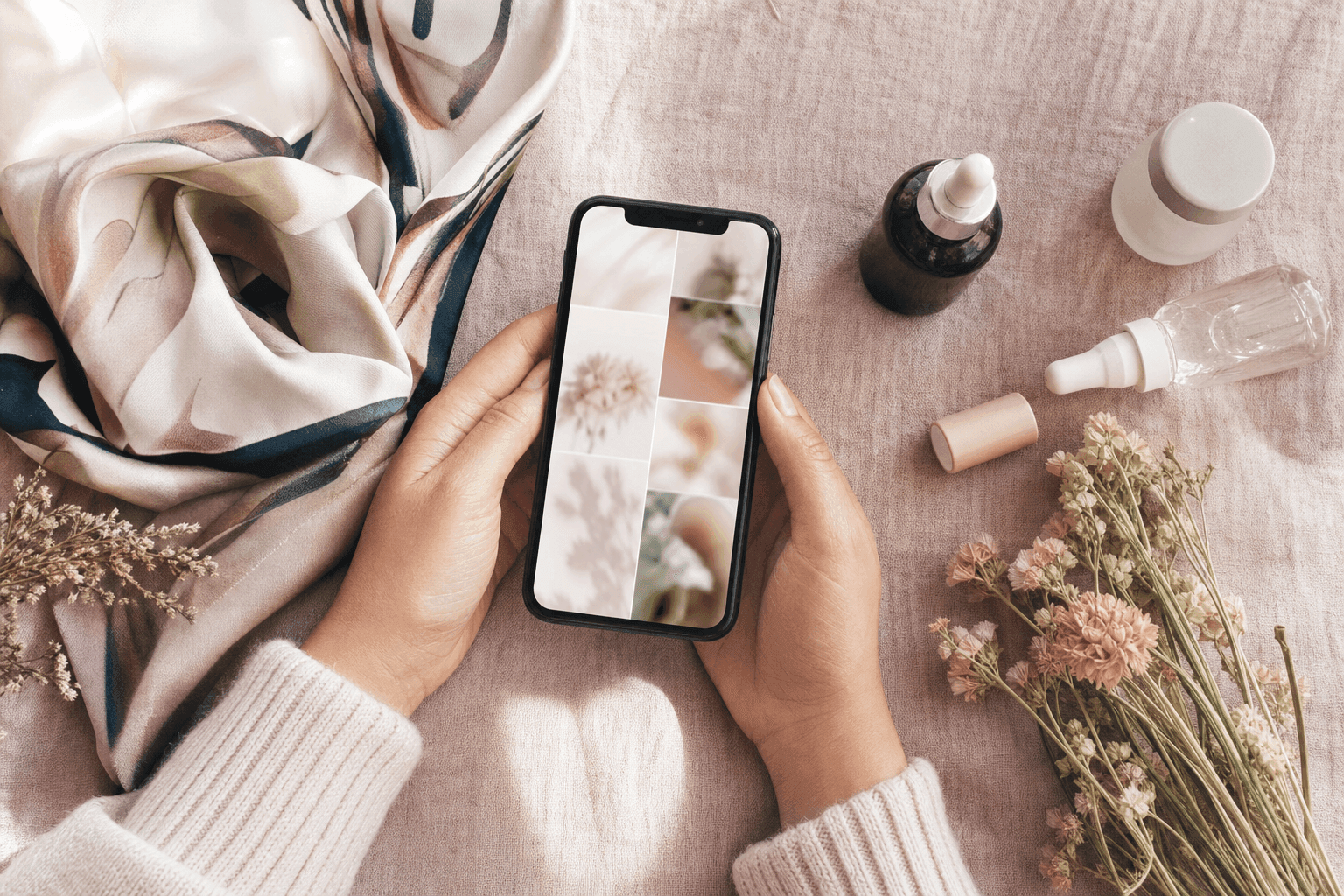 A shopper scrolling a RedNote beauty feed on her phone beside skincare bottles and dried flowers
